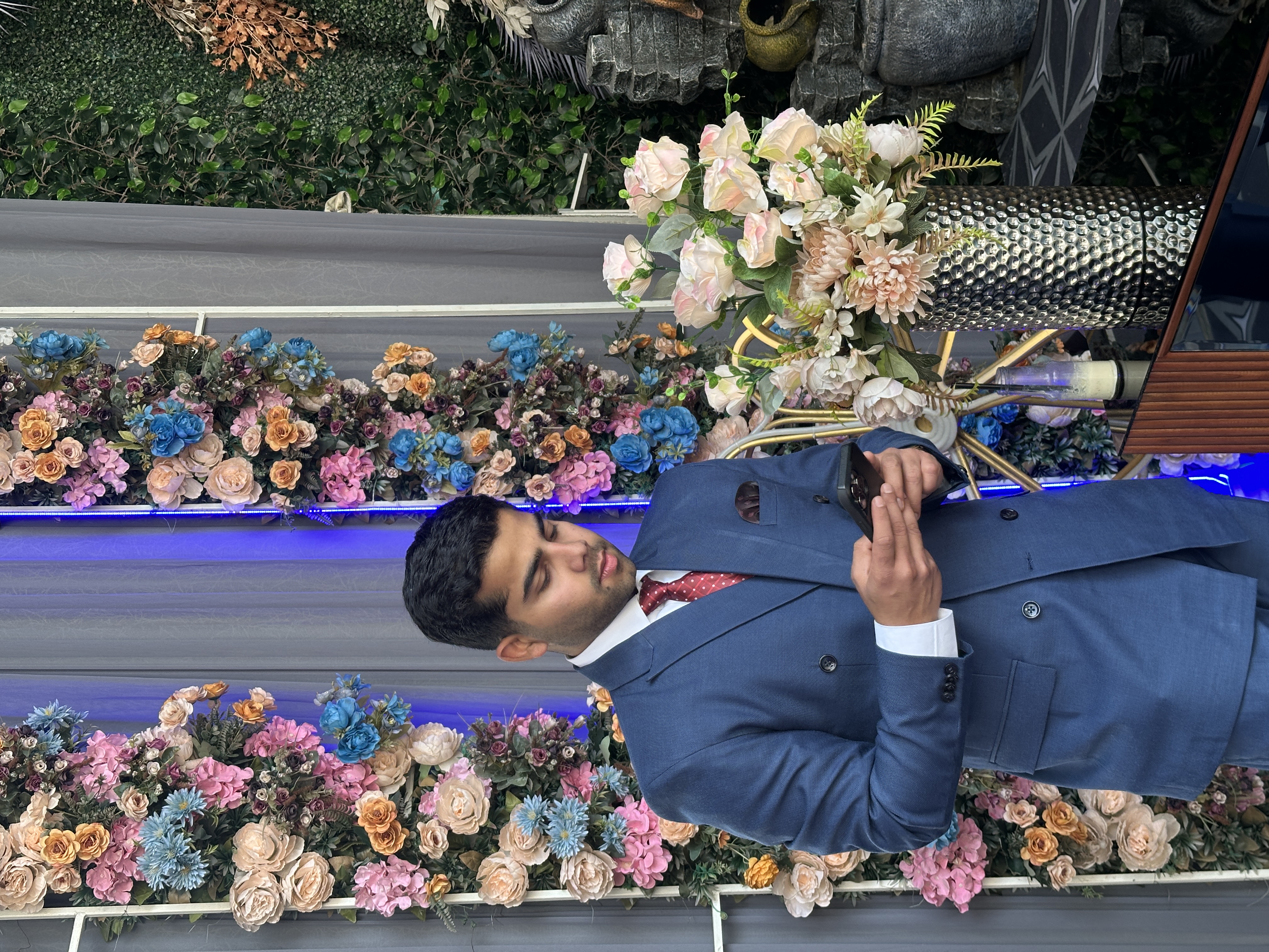 Abhi in professional setting with flowers
